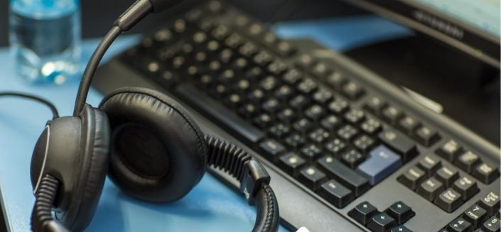 Headphones and computer keyboard in an interpreting booth