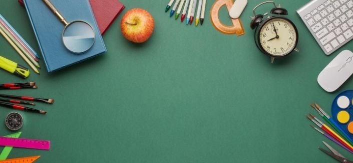 Various school-related items on a table to illustrate education