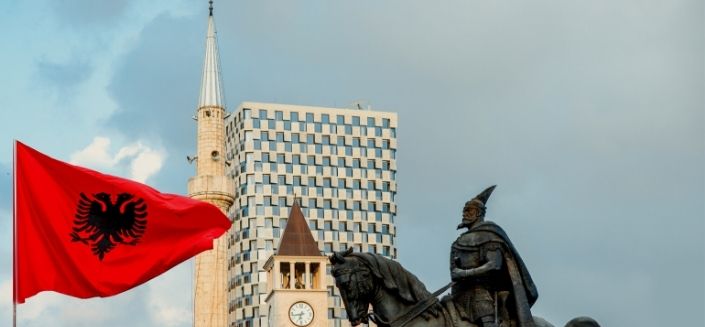 The Skanderbeg monument and Albanian flag in Tirana, Albania.