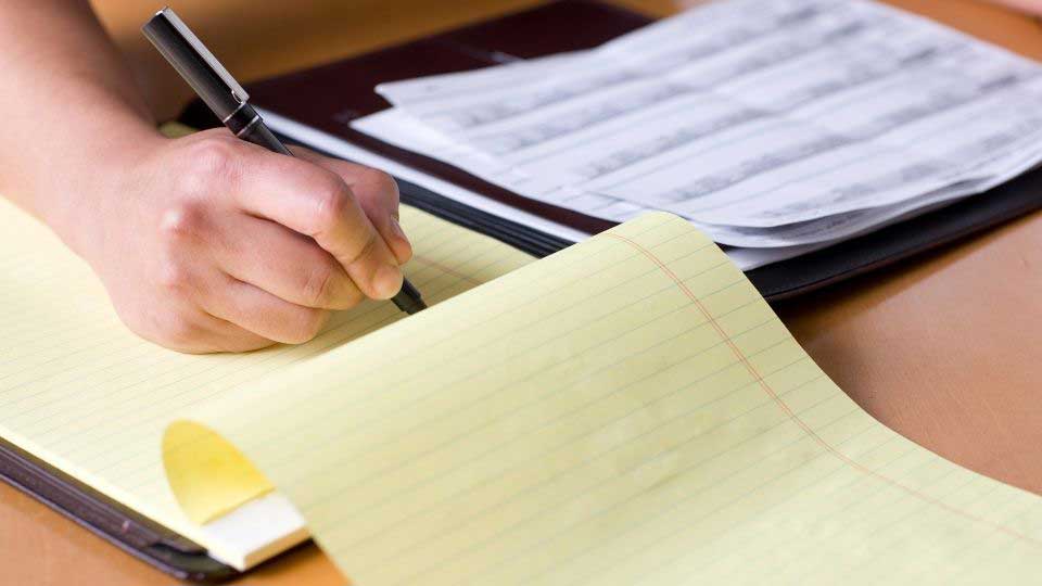 Interpreter writing on a notepad